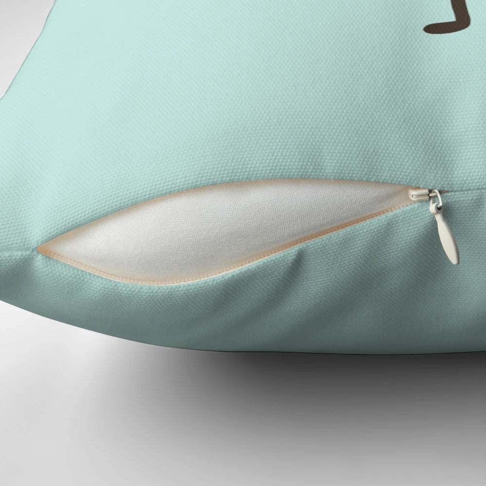 A plush, green avocado-shaped pillow with a cute, smiling face