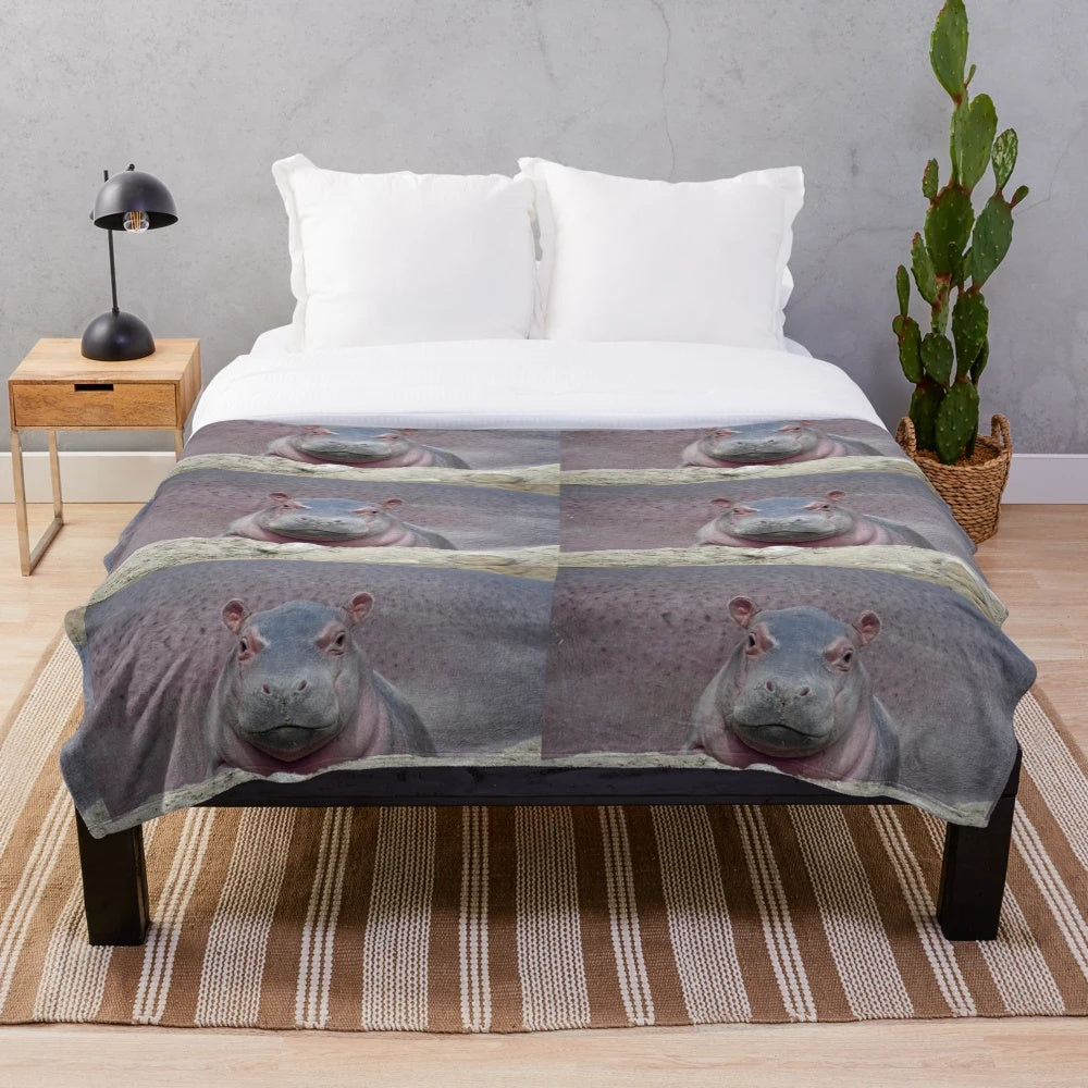 Soft and cozy plush blanket featuring the adorable baby hippo Fritz from the Cincinnati Zoo