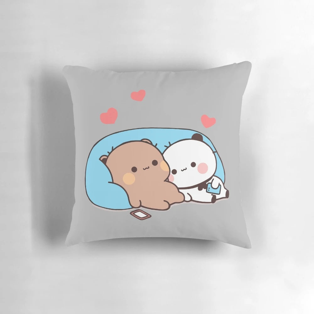 A plush pillow featuring the cartoon characters Dudu Bear and Bubu Panda, snuggling together under red hearts.