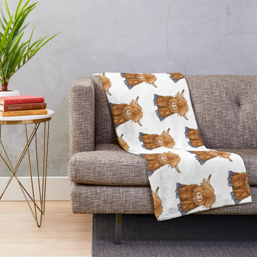 Cozy plush highland cow blanket with soft, fluffy texture