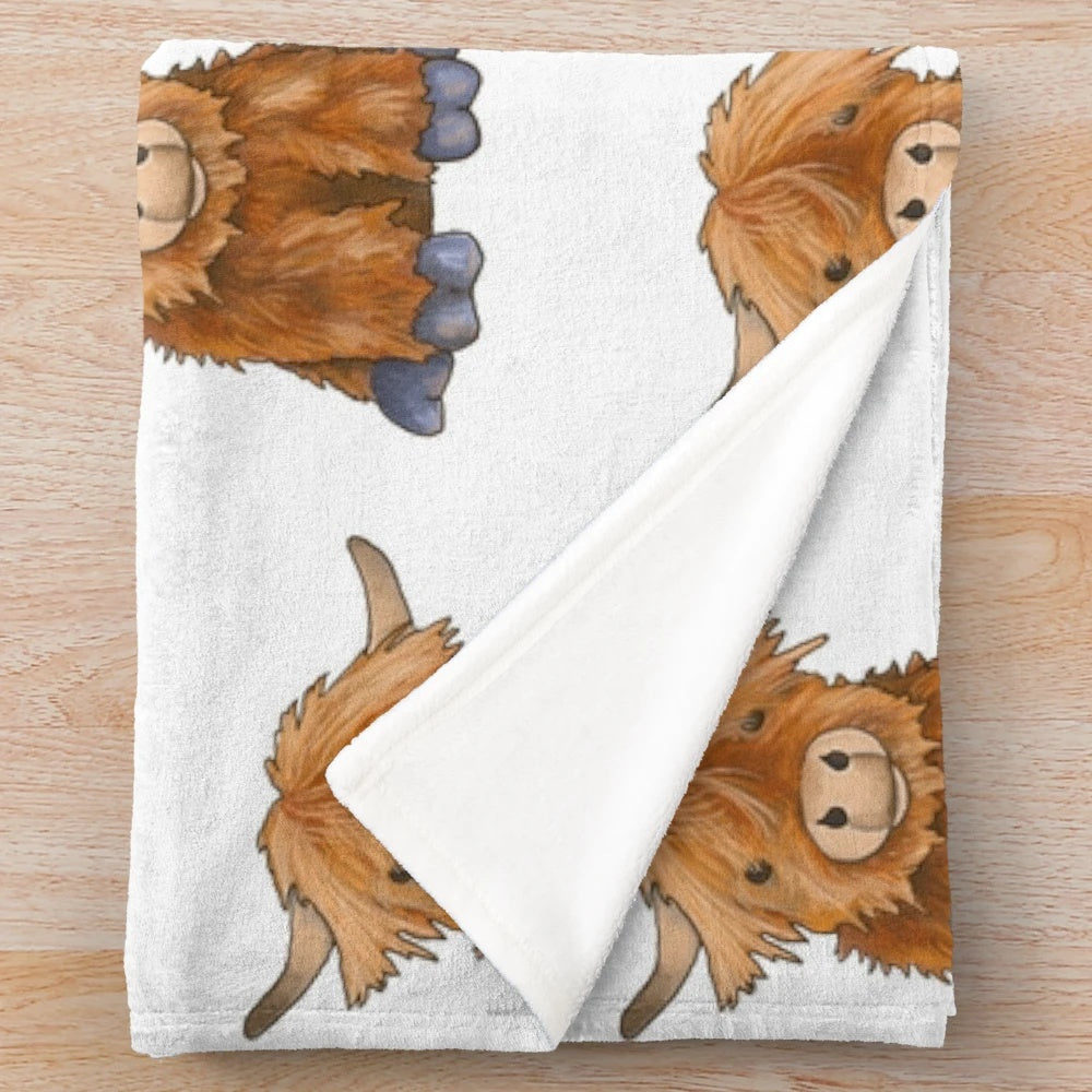 Cozy plush highland cow blanket with soft, fluffy texture