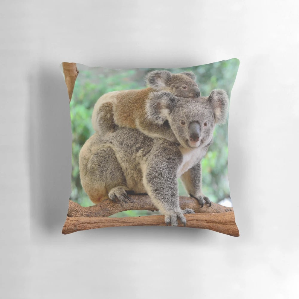 Soft and plush pillow featuring a mother koala and her baby joey relaxing in a tree