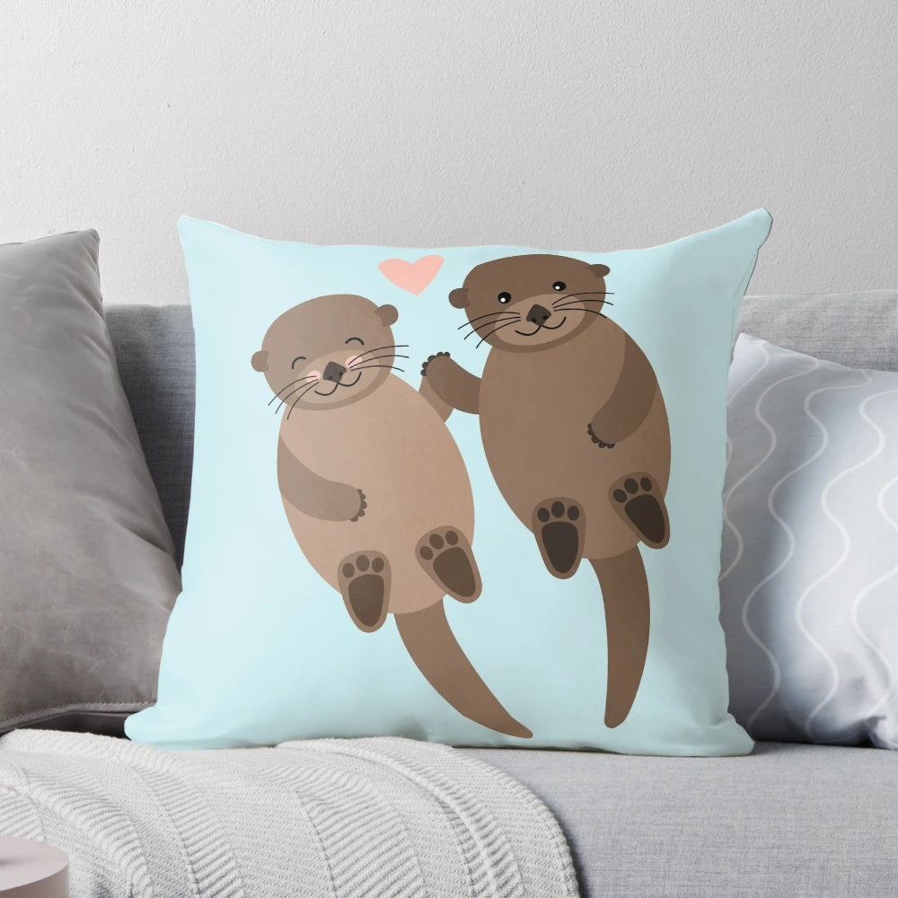 Soft, plush pillow featuring a heart-shaped design with two adorable otters cuddling.