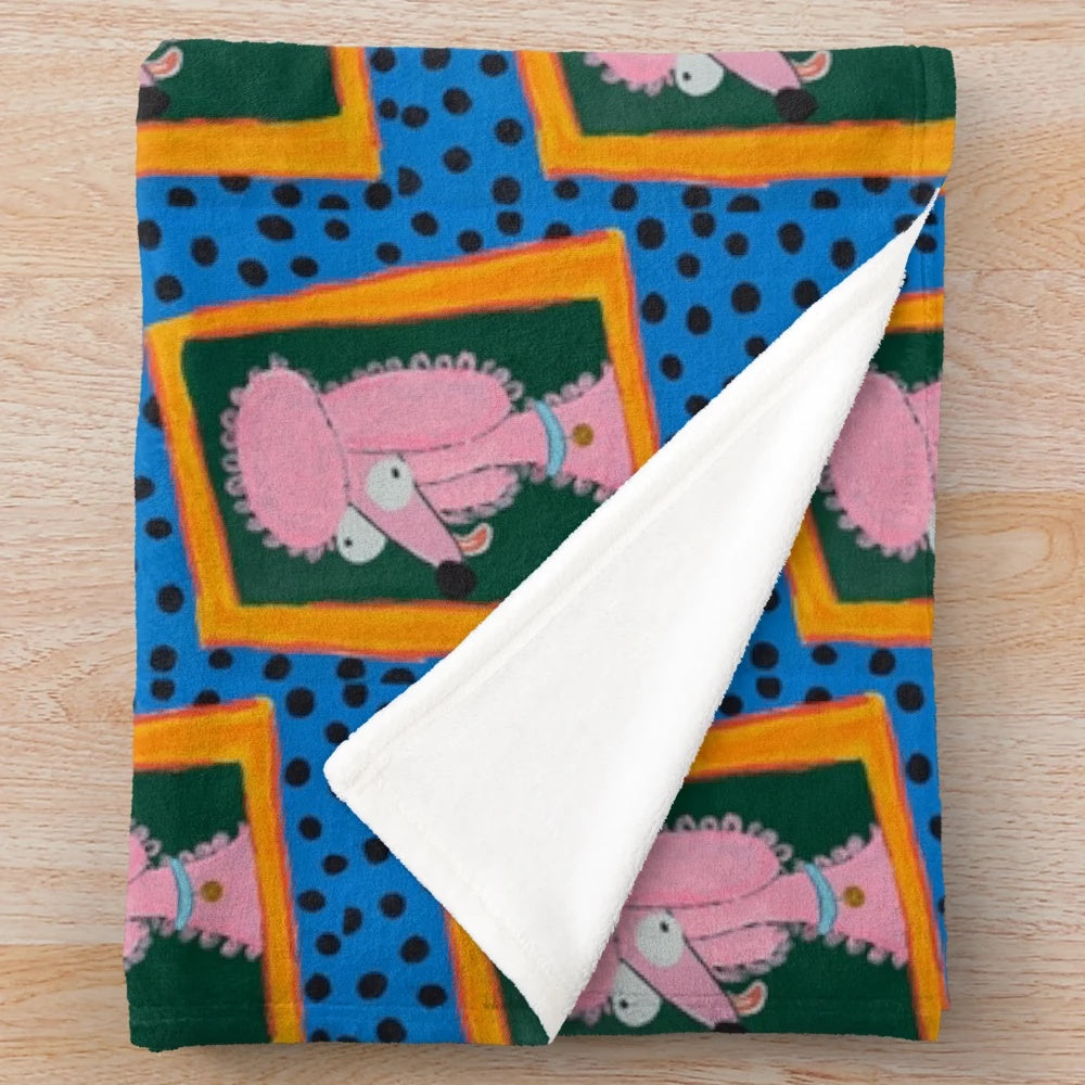 Soft and fluffy pink poodle plush blanket with a fun and vibrant polka dot pattern