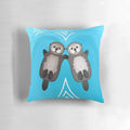 Adorable sea otters holding hands on a plush decorative pillow
