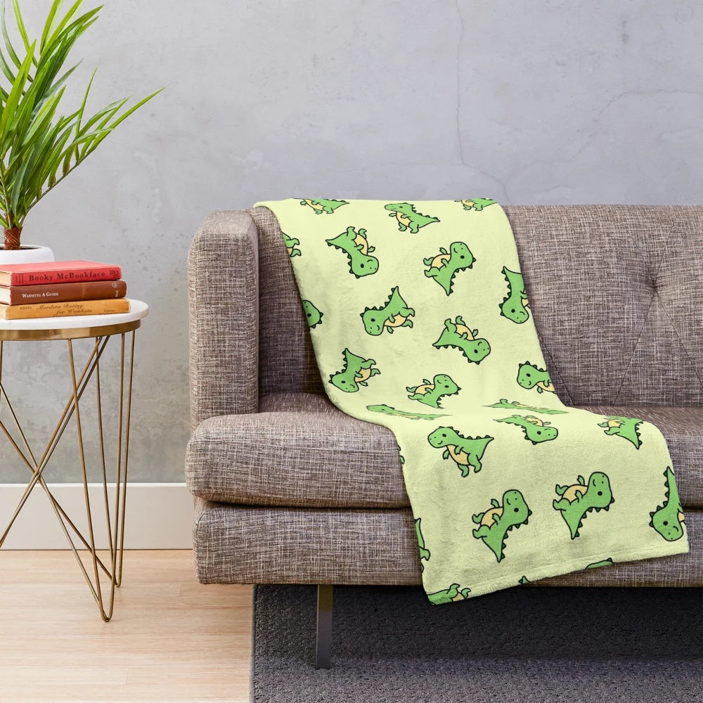 Cuddly T. Rex plush blanket with a green and teal color scheme
