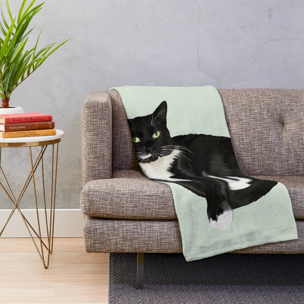 Soft and cozy plush blanket with a tuxedo cat portrait