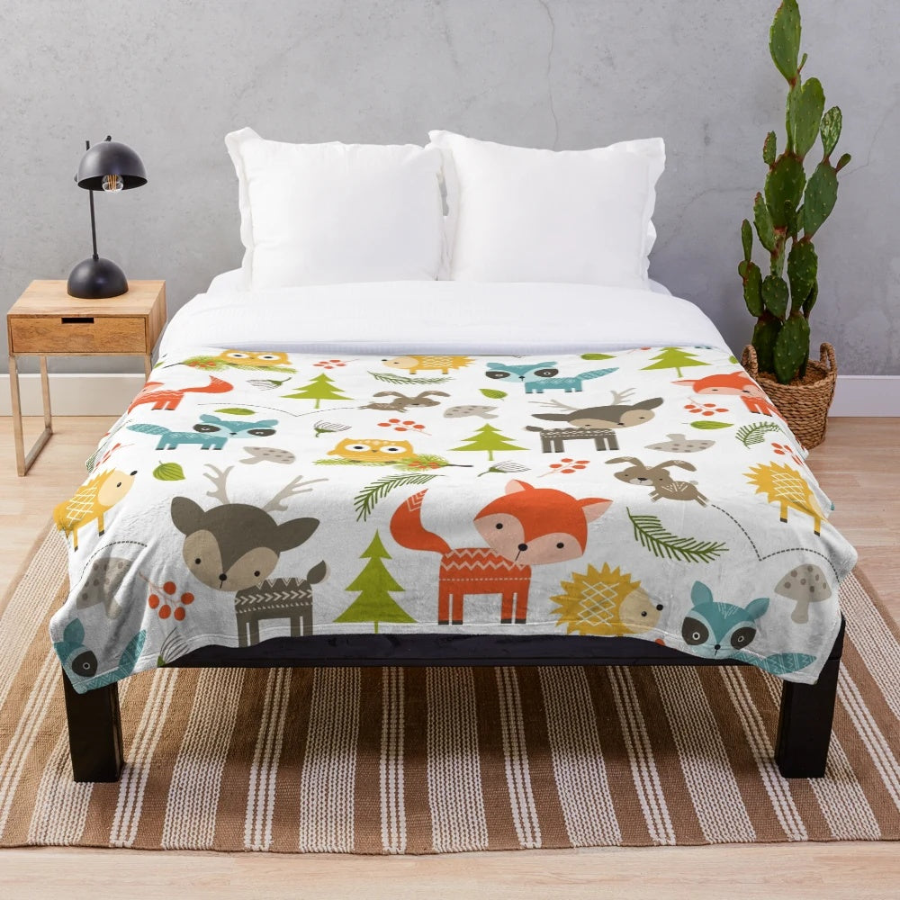 Woodland animals plush blanket with raccoons, deer, foxes, and owls