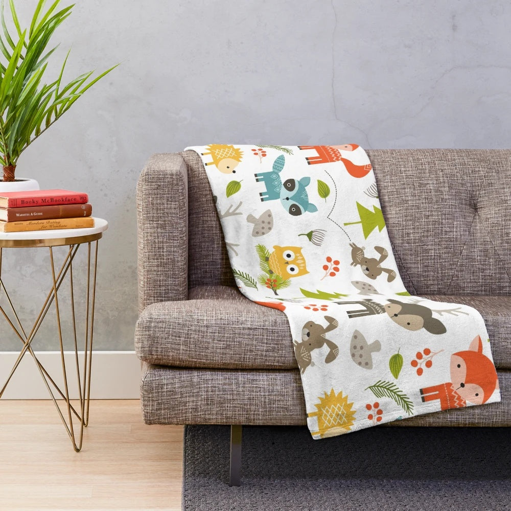 Woodland animals plush blanket with raccoons, deer, foxes, and owls