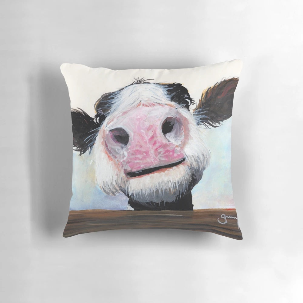 Whimsical cow pillow with a curious, cheeky expression