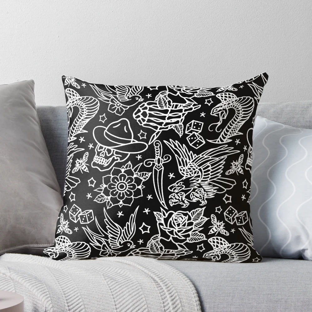 Decorative throw pillow featuring a collage of American traditional tattoo designs including eagle, skull, flower, dagger, snake, rose, sparrow, bee, skeleton hand, and dice.
