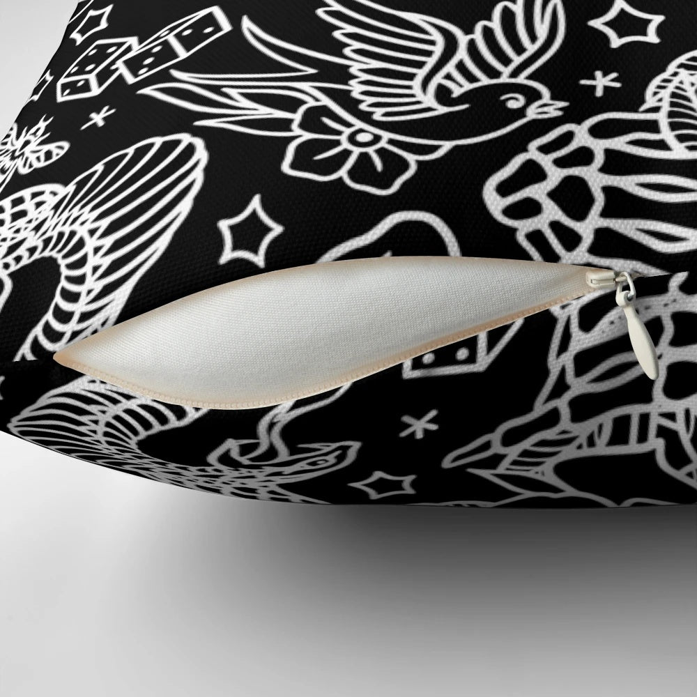Decorative throw pillow featuring a collage of American traditional tattoo designs including eagle, skull, flower, dagger, snake, rose, sparrow, bee, skeleton hand, and dice.