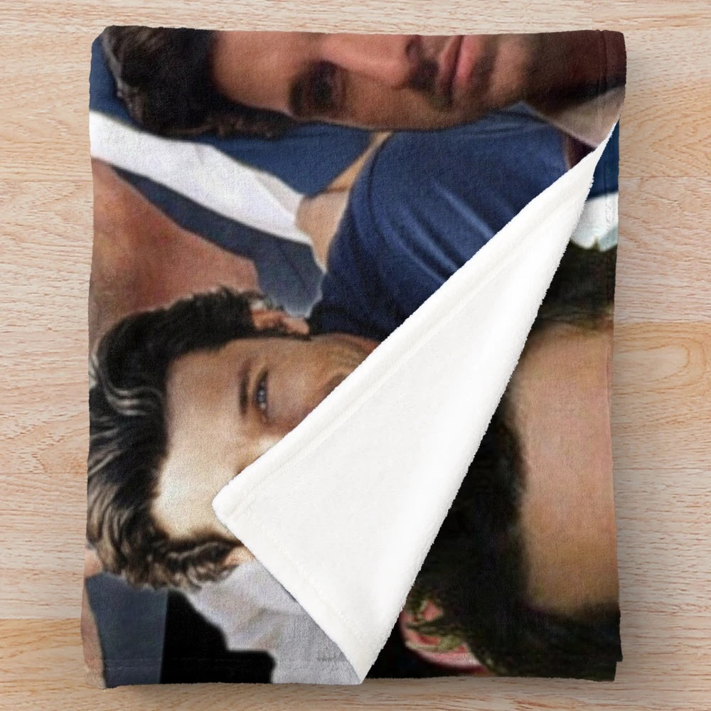 A plush blanket featuring a collage of Patrick Dempsey's photos
