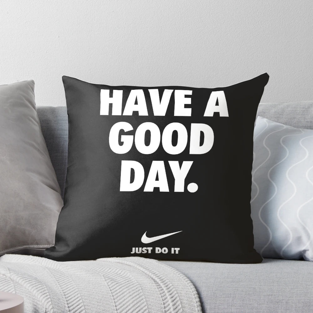 Black pillow with a motivational phrase in Nike-inspired typography