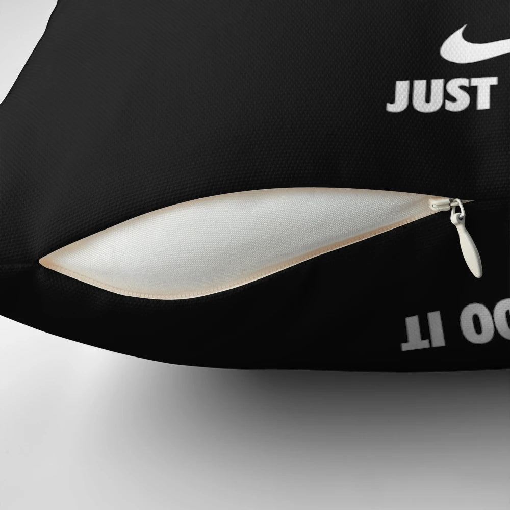 Black pillow with a motivational phrase in Nike-inspired typography