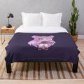 Cute chibi anime girl with purple hair and eyepatch on plush blanket