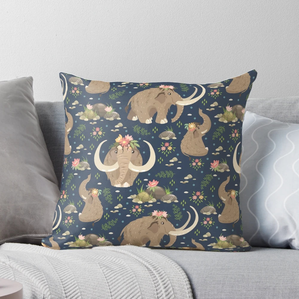 A cozy blue and white throw pillow featuring an adorable extinct mammoth design with a nature-inspired ethnic floral pattern.