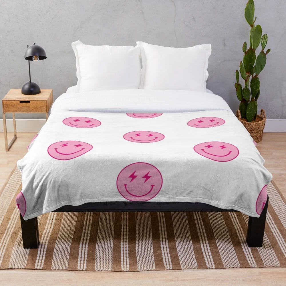 Hot pink plush blanket with lighting bolt and smiley face design