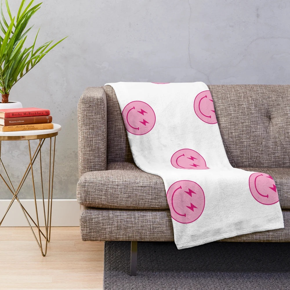 Hot pink plush blanket with lighting bolt and smiley face design