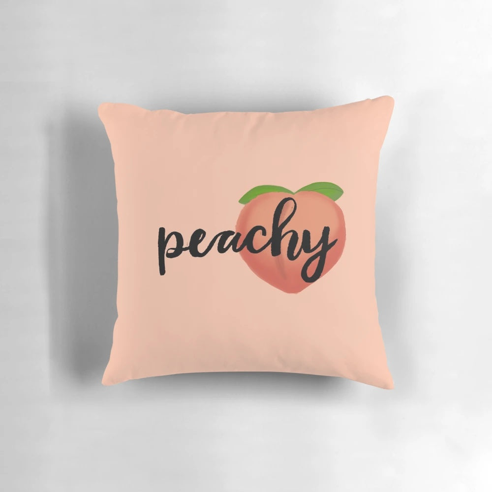 A soft, peach-colored pillow with a cute cartoon emoji design, perfect for adding a pop of color and personality to any room.
