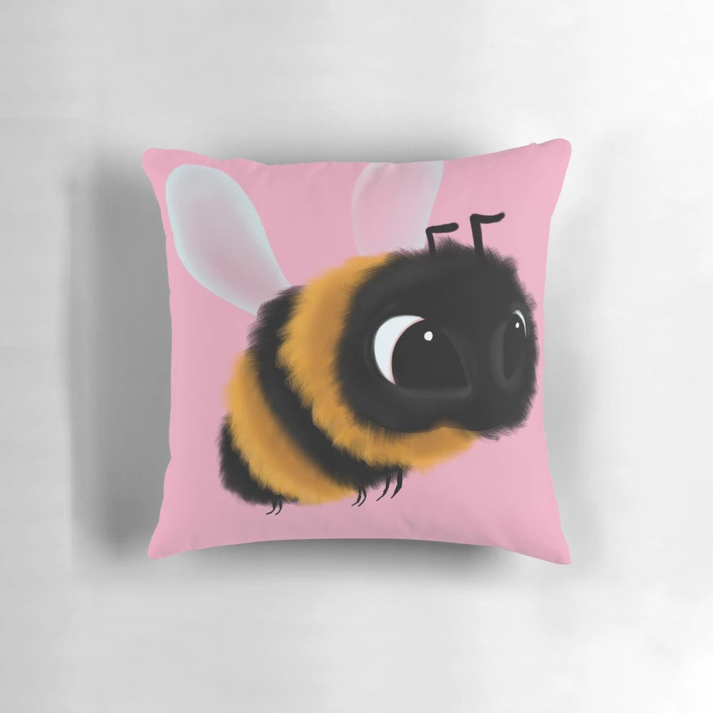 A colorful, fluffy, and cute bee-shaped decorative throw pillow with a pink background.