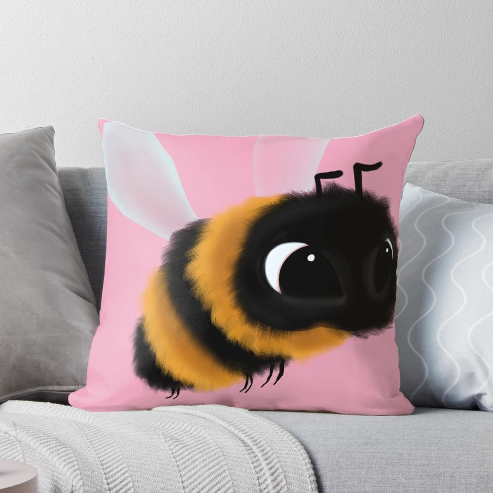 A colorful, fluffy, and cute bee-shaped decorative throw pillow with a pink background.