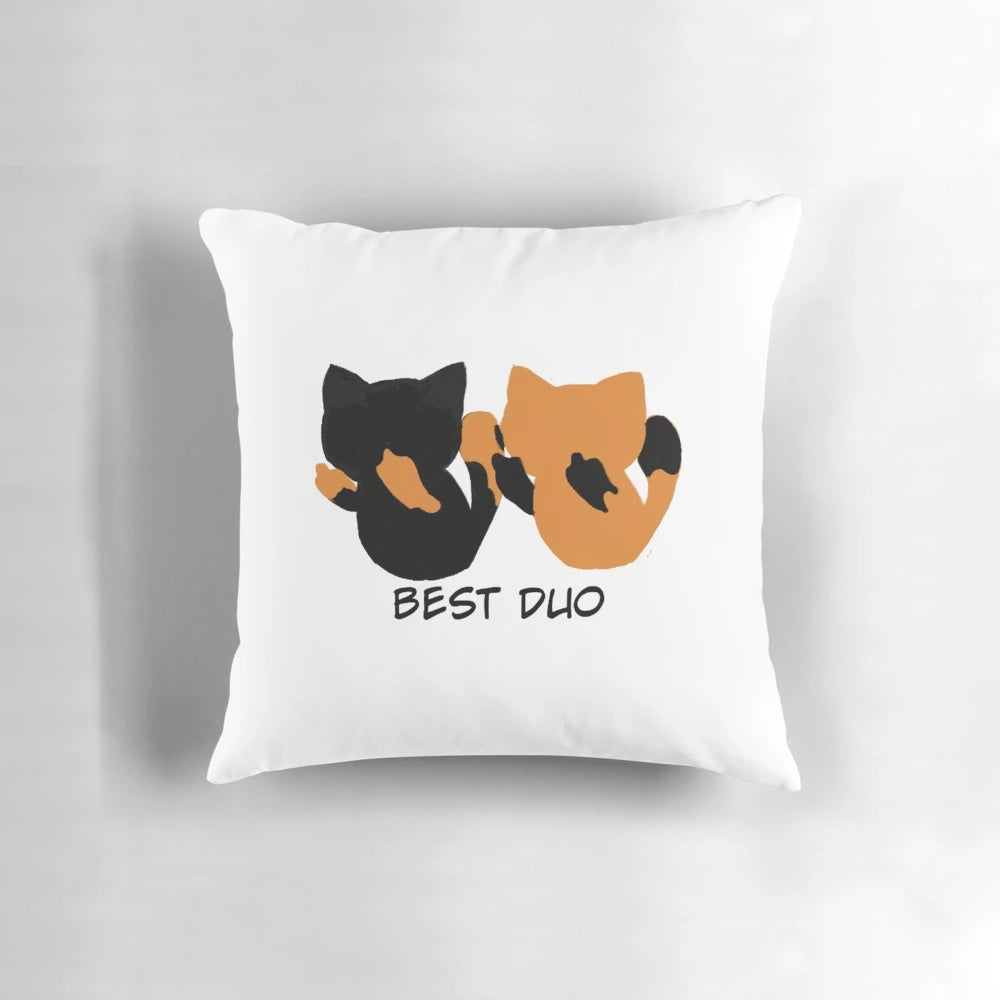 Two adorable kittens snuggling on a soft, plush pillow