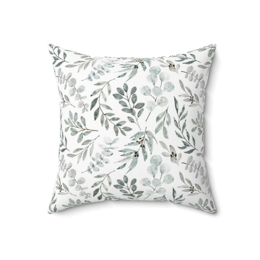 Watercolor painting of green eucalyptus leaves on a decorative pillow cover