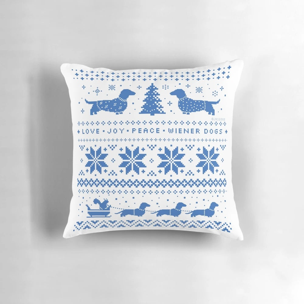 A cozy dachshund Christmas pillow featuring a blue and white holiday pattern, perfect for dog lovers and home decor.