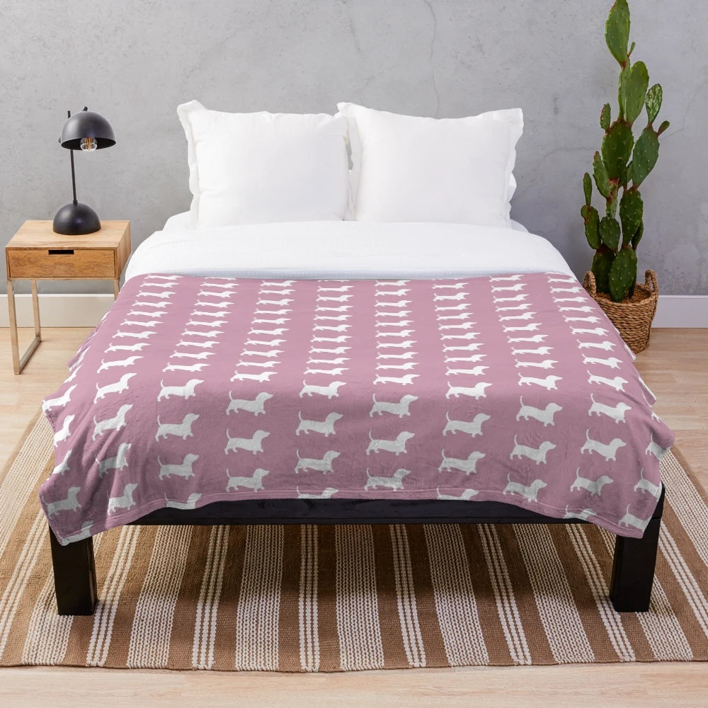 Dusty pink plush blanket with dachshund silhouette design