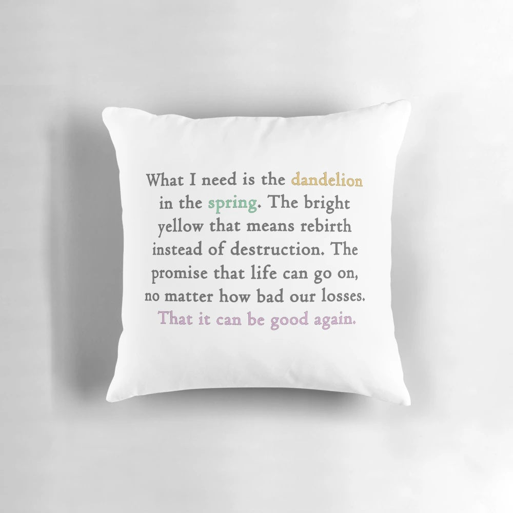 A decorative pillow featuring a quote from the Hunger Games movie with an image of a dandelion.