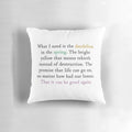 A decorative pillow featuring a quote from the Hunger Games movie with an image of a dandelion.