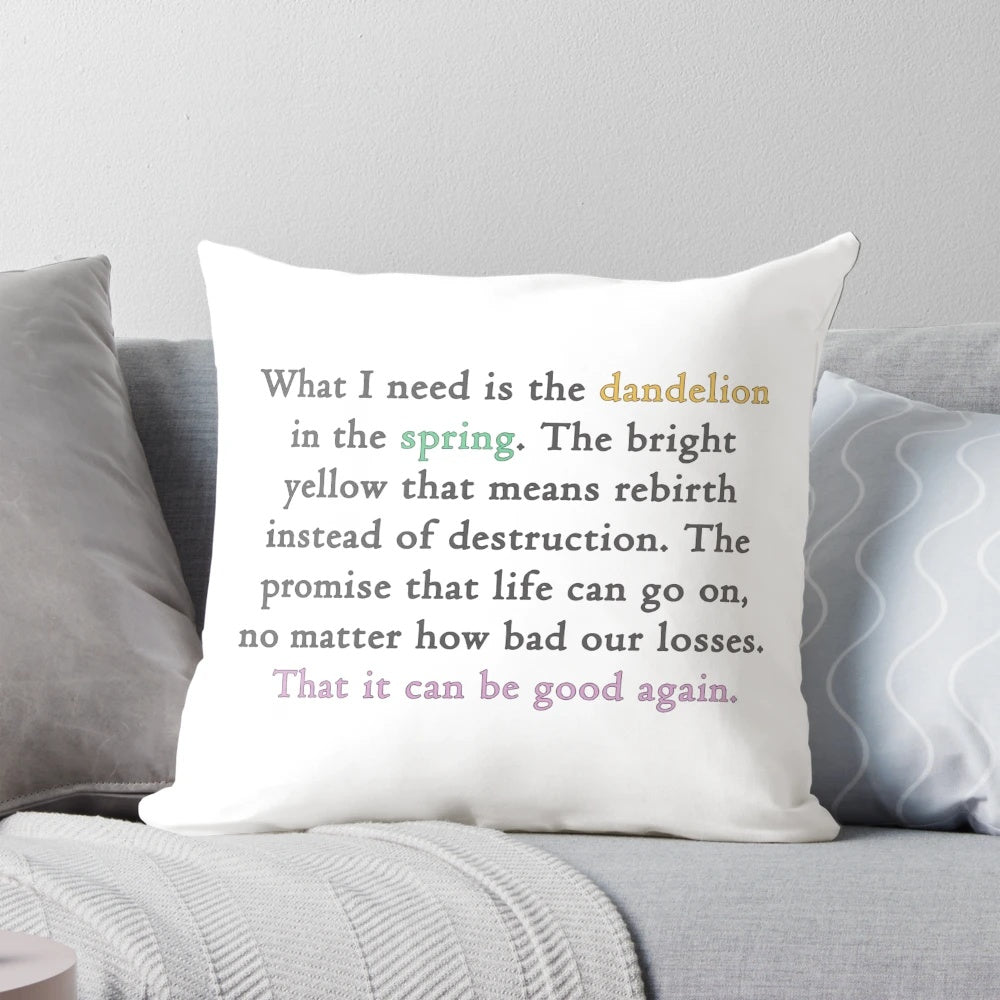 A decorative pillow featuring a quote from the Hunger Games movie with an image of a dandelion.