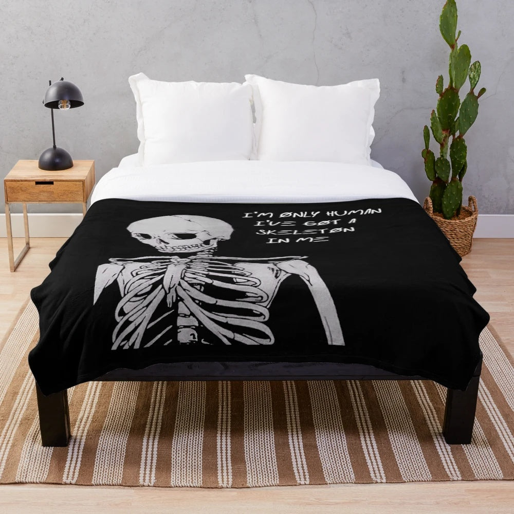 Dark and edgy plush blanket featuring a skeleton design with the text "I'm Only Human