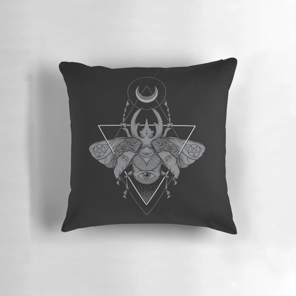 A dark and eerie pillow featuring a geometric occult beetle or scarab design in a pointillism style.