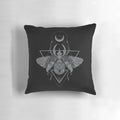 A dark and eerie pillow featuring a geometric occult beetle or scarab design in a pointillism style.