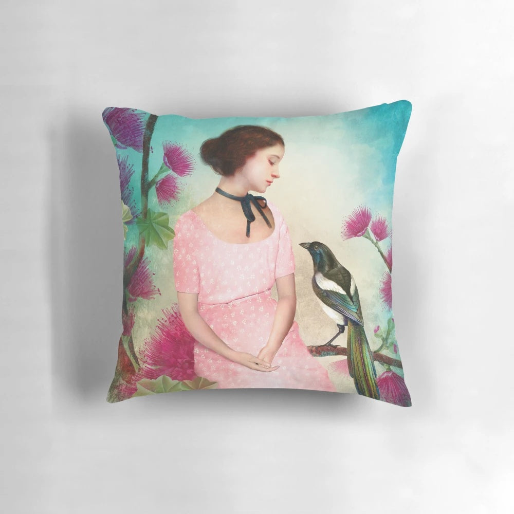 A soft, plush pillow featuring a dreamy, artistic design with a girl, bird, and nature elements.