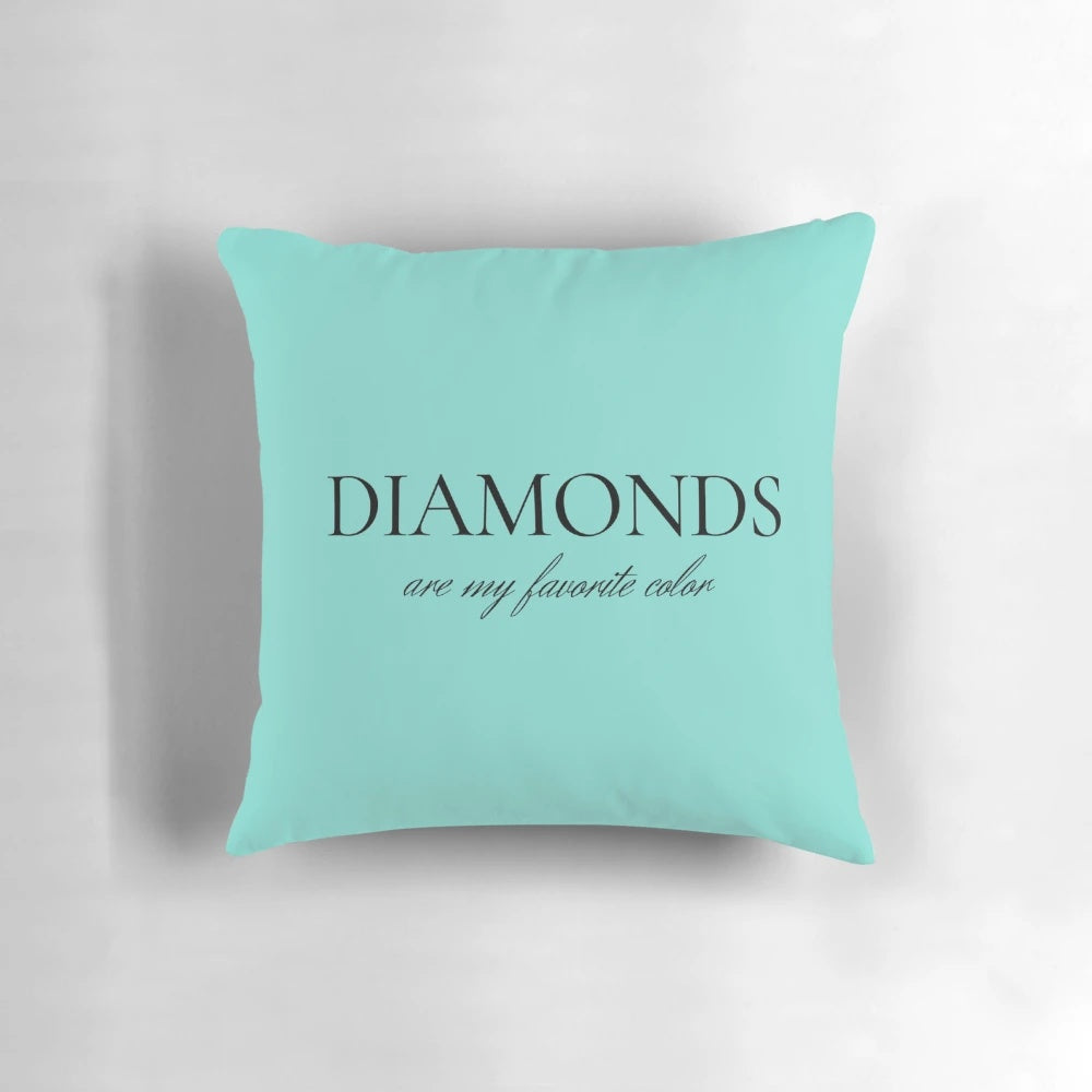 Decorative throw pillow with a diamond-inspired design in shades of blue and white.