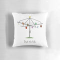 A white square pillow with a whimsical "Deck the Hills" design, featuring Australian imagery like a Hills Hoist clothesline.