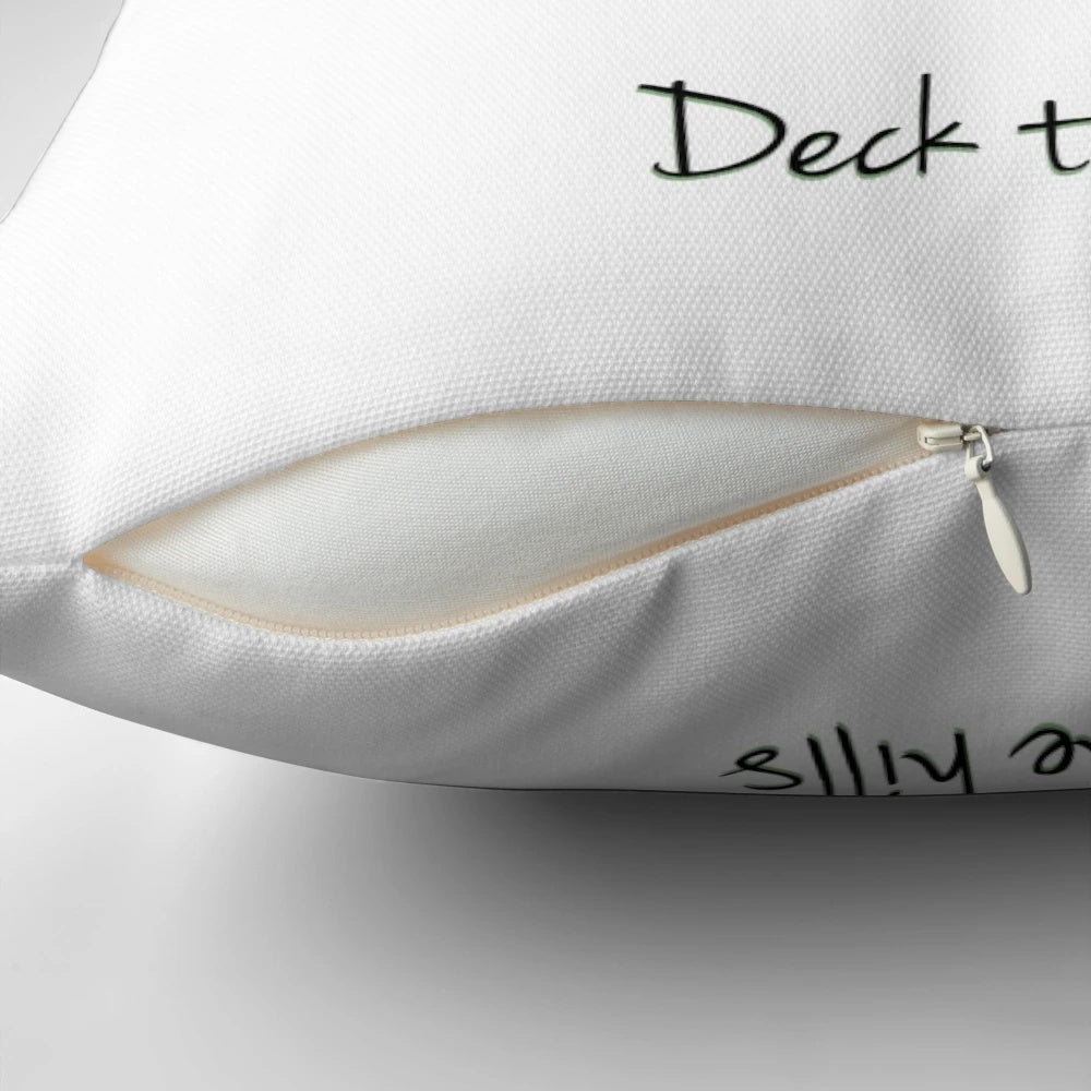 A white square pillow with a whimsical "Deck the Hills" design, featuring Australian imagery like a Hills Hoist clothesline.