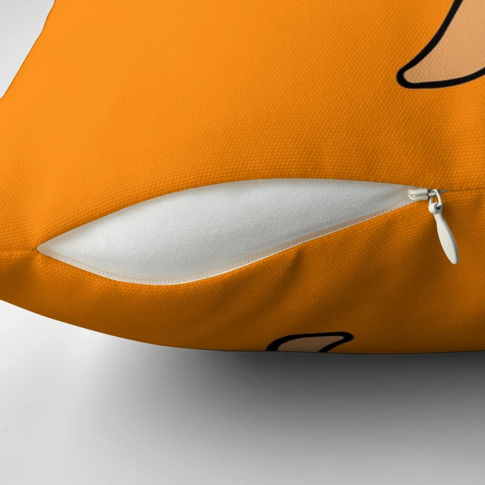 An orange-colored decorative throw pillow featuring a camel design by Everything Eli.