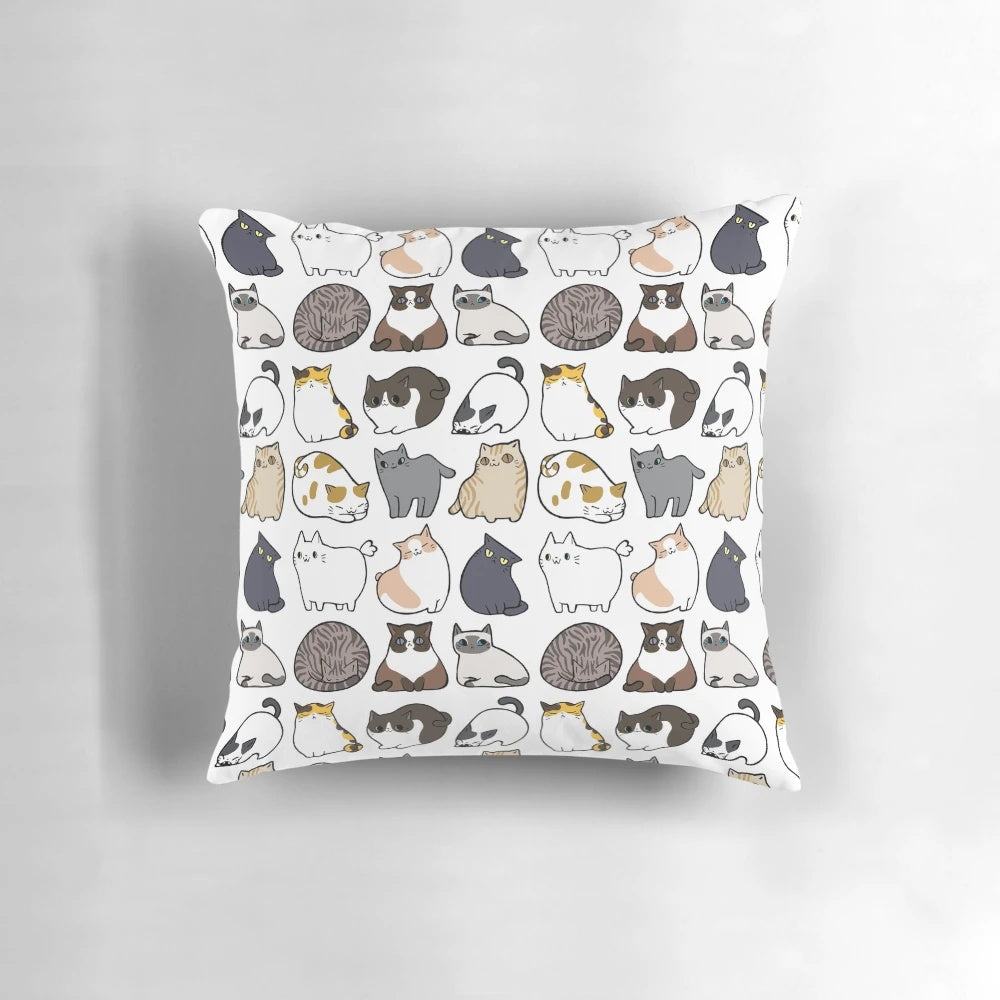 Decorative throw pillow featuring a repeating pattern of adorable cartoon cats in various colors and poses.
