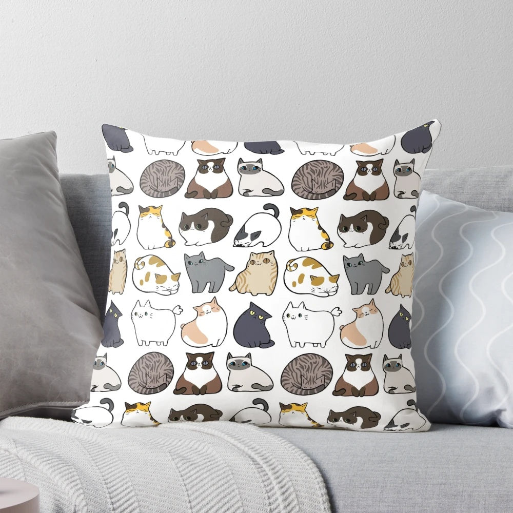 Decorative throw pillow featuring a repeating pattern of adorable cartoon cats in various colors and poses.