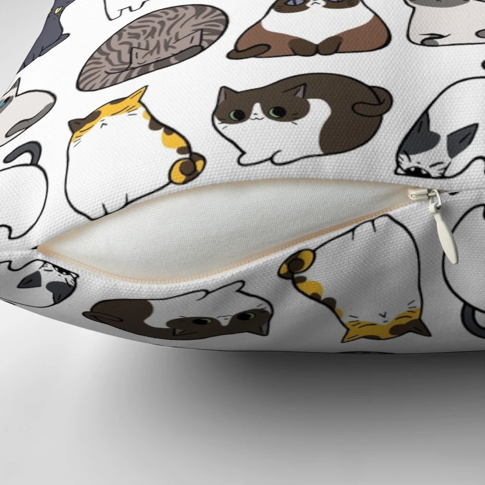 Decorative throw pillow featuring a repeating pattern of adorable cartoon cats in various colors and poses.