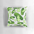 Close-up image of a decorative pillow featuring a vibrant, abstract cucumber pattern in various shades of green.