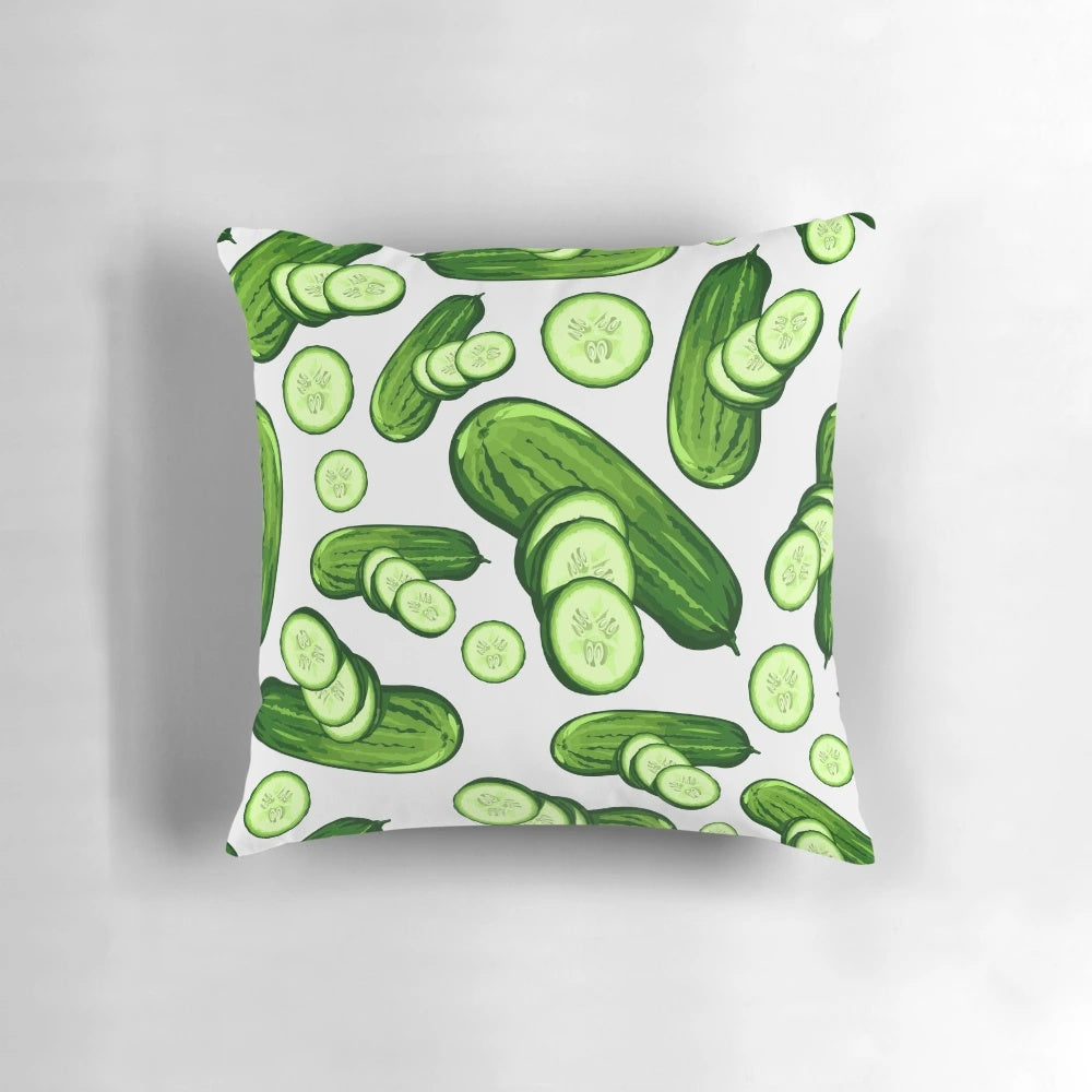 Close-up image of a decorative pillow featuring a vibrant, abstract cucumber pattern in various shades of green.