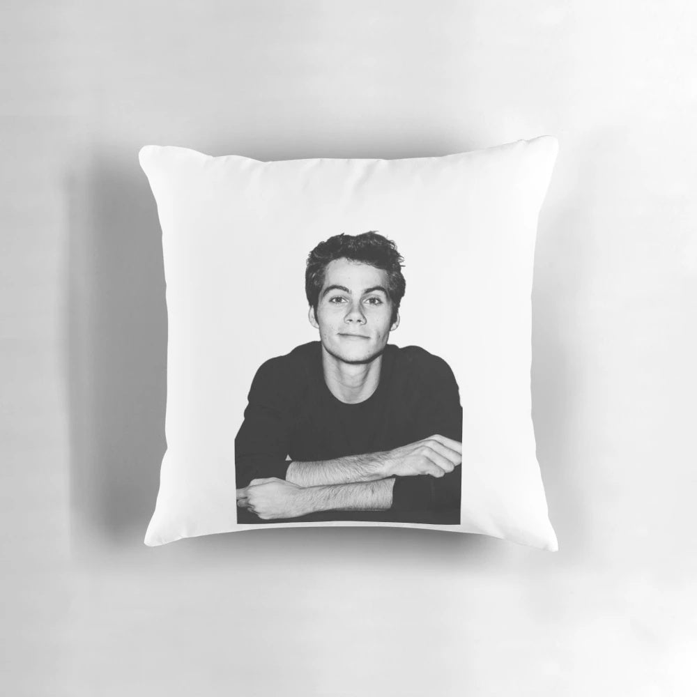 A stylish pillow featuring the image of Dylan O'Brien, the popular actor from Teen Wolf.