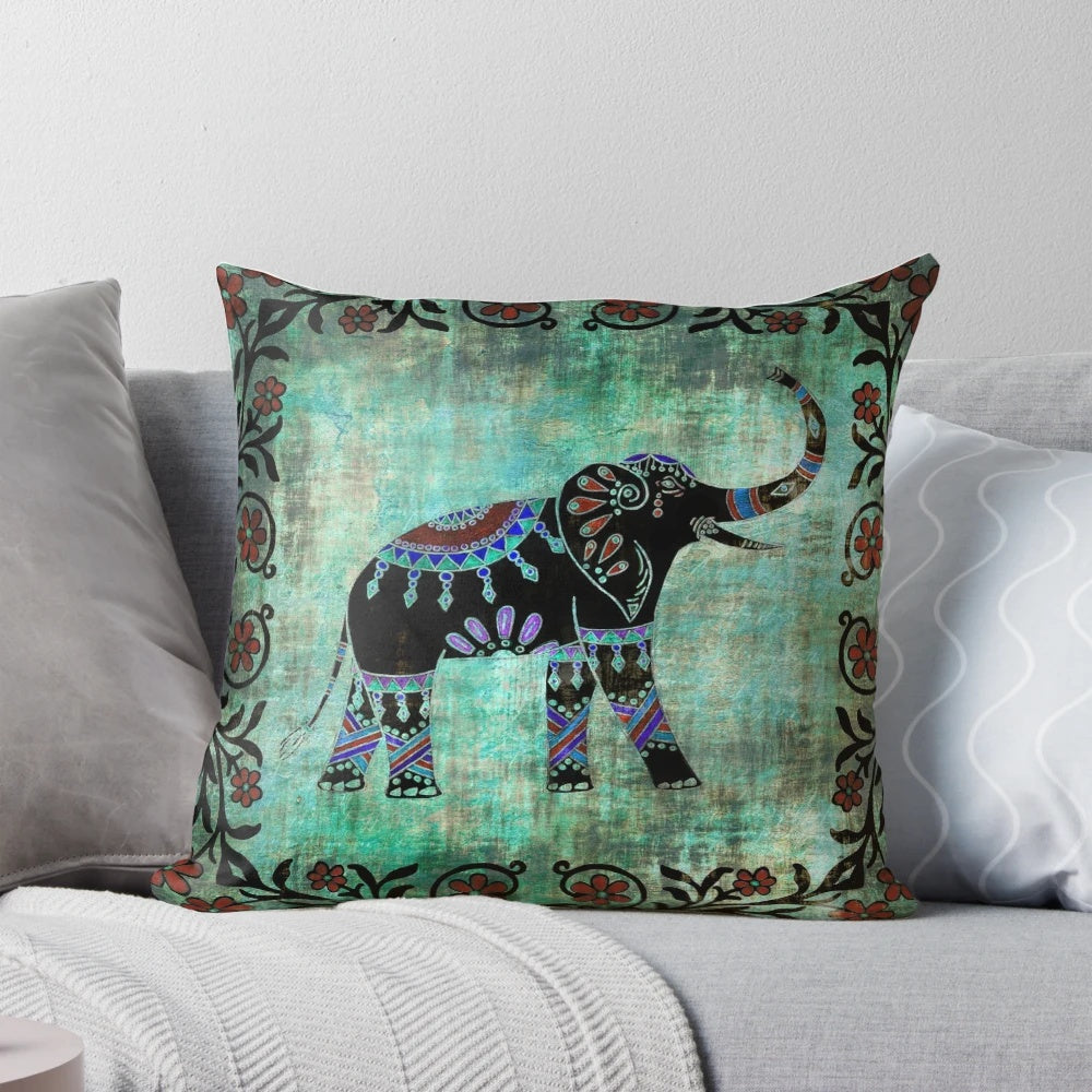 Decorative throw pillow featuring a vibrant elephant design with intricate Indian and Asian-inspired floral patterns in shades of blue and teal.