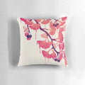 A decorative pillow featuring a whimsical, abstract watercolor design of ginkgo leaves and flowers in soft pink and purple hues.