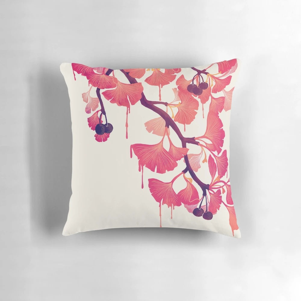 A decorative pillow featuring a whimsical, abstract watercolor design of ginkgo leaves and flowers in soft pink and purple hues.
